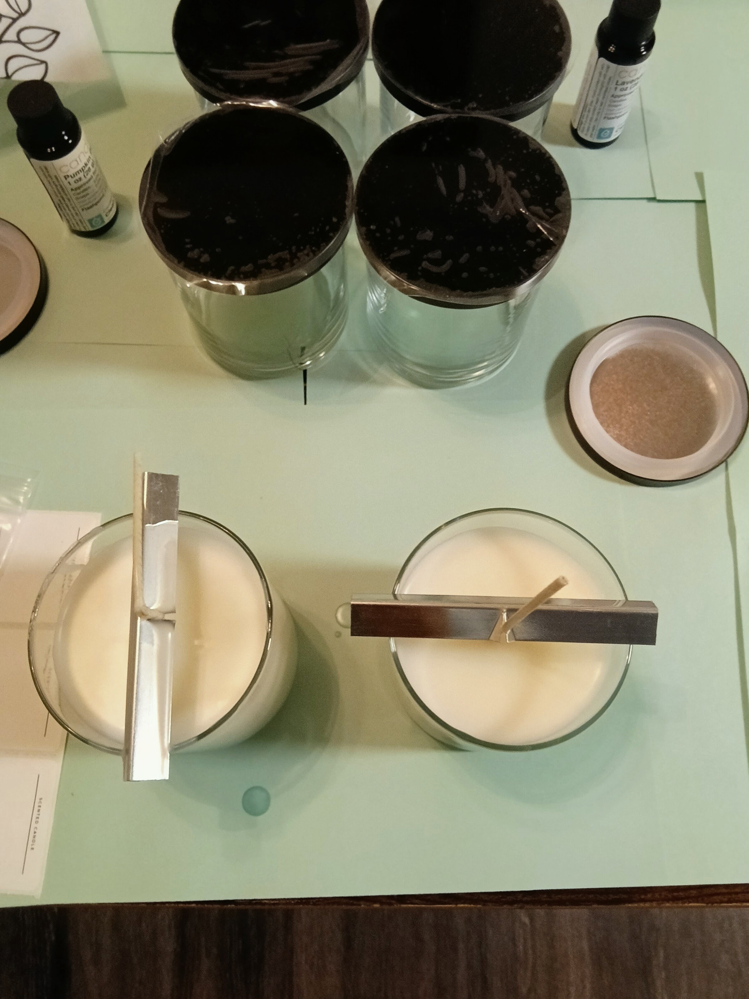 Candles cooling overhead view, wicks centered